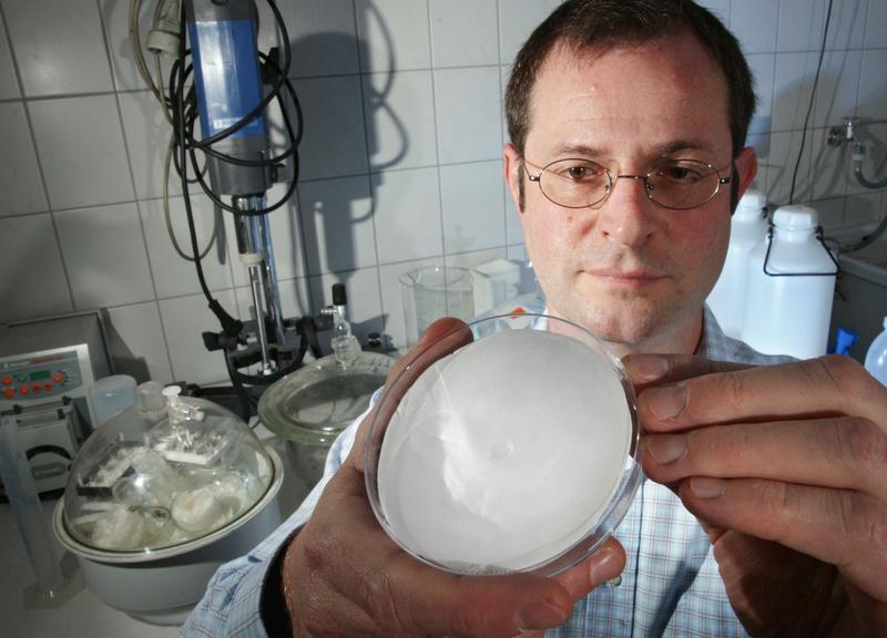 Der Materialwissenschaftler Prof. Dr. Frank A. Müller von der Uni Jena betrachtet eine Materialprobe, die die körpereigene Knorpelbildung wieder anregen soll.