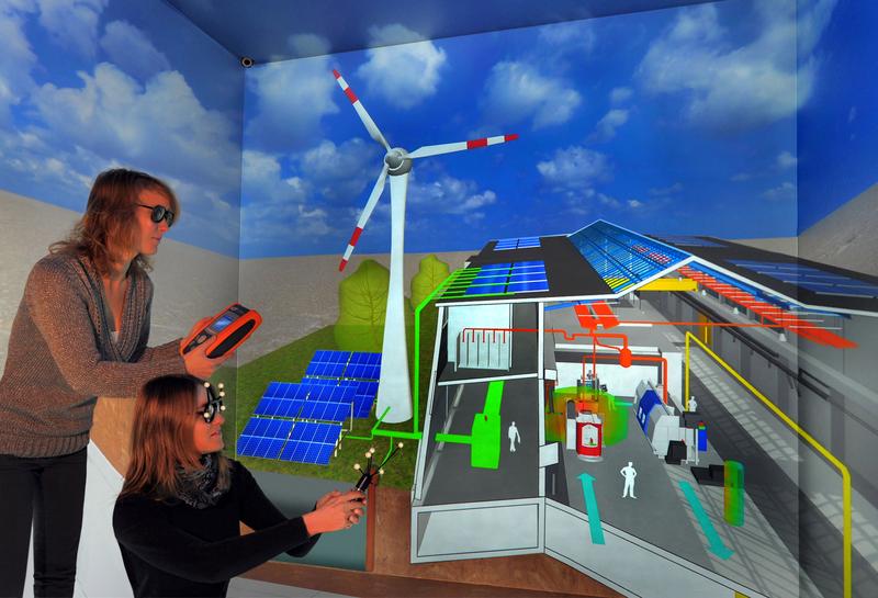 Im „Virtual Reality Center Production Engineering“ der Technischen Universität Chemnitz suchen Lilly Meynerts und Romy Lindner (v.l.) in der Simulation einer virtuellen Modellfabrik nach Schwachstellen beim Energieverbrauch, um Optimierungsstrategien ableiten zu können. Beide Wissenschaftlerinnen gehören zum Team des Spitzentechnologieclusters eniPROD. 