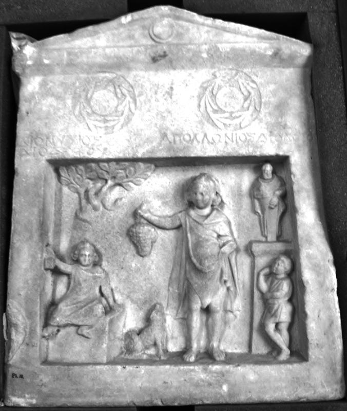 Tombstone placed over the grave of two brothers. The boy to the left is sitting on a grave monument. From Smyrna.