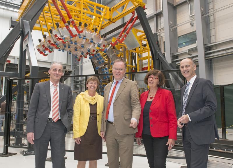 Prof. Dr. Bernd Mayer, Silvia Nieber, Stephan Weil, Petra Tiemann und Dr. Dirk Niermann  (v. l. n. r.) vor der Anlage zur automatisierten Montage von Flugzeugrümpfen