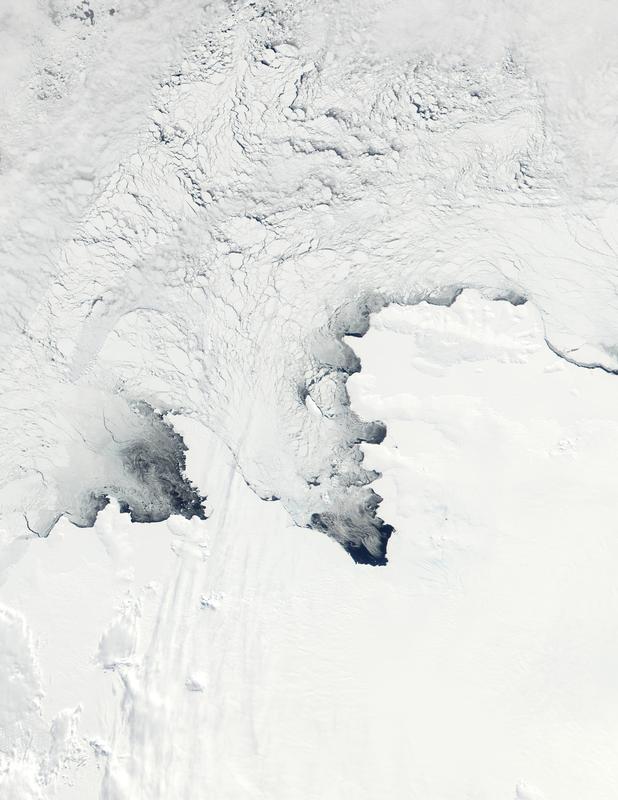 Cold southerly winds push sea ice away from the Antarctic coast, leading to new ice formation in the open water (polynya) along the coast. Satellite image by Terra-MODIS on October 23, 2001 