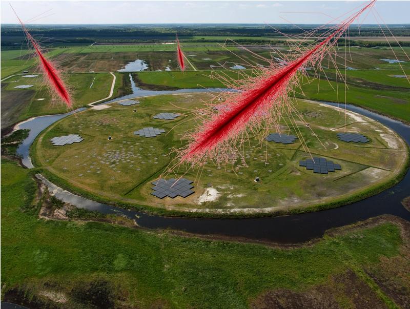 Image of air showers, simulated with CORSIKA, mounted onto a photo of the central station (“superterp”) of the LOFAR telescope network near Exloo/Netherlands.