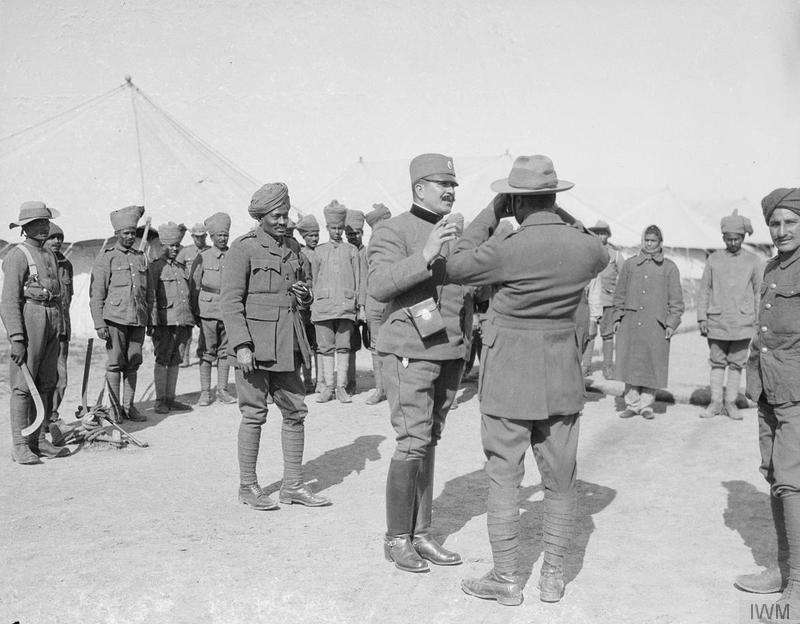 A Serbian Colonel showing an Indian Offcer how to use a Camera. Salonika, March 1917