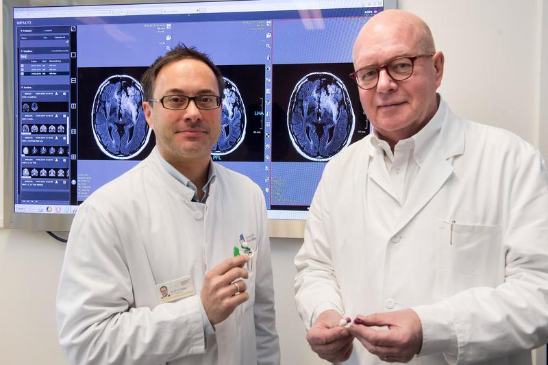 Telemedicine for epilepsy patients: Prof. Dr. Christian Elger (right) and Private Docent Dr. Rainer Surges of the Department of Epileptology of the University Hospital Bonn with the minisensor. 