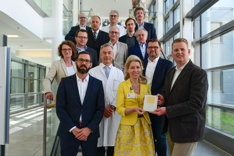 Auszeichnung für nachhaltiges Planen und Bauen im Herz- und Diabeteszentrum NRW: Vorne v.l. Marcus Herget (DGNB e.V.) hat den Preis an Dr. Karin Overlack und Marc Lohmeier (HDZ) überreicht