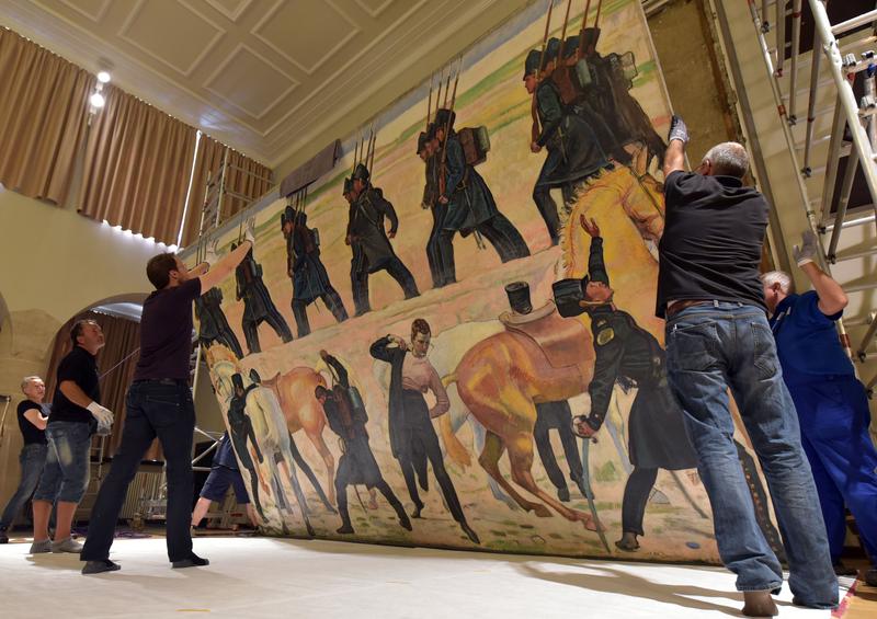 In der Aula der Universität Jena wird das großformatige Gemälde von Ferdinand Hodler abgehängt, bevor es restauriert und anschließend in der Bundeskunsthalle in Bonn ausgestellt wird.  