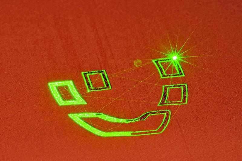 Picture 1: Exposure of a single layer in a SLM process with green laser light to manufacture an internally cooled coil for inductive heat treatment.