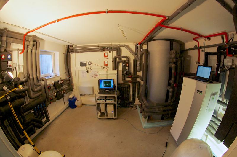 Heating room with measurement equipment (in the center), heat pump and buffer storage.