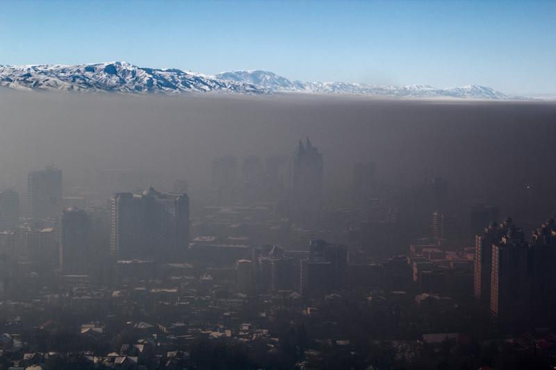 Smart energy and mobility not only safeguard the global climate but also life in urban habitats; smog over Almaty, Kazakhstan.
