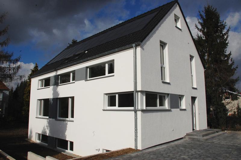 Demonstration building for a new solar house concept with direct solar thermal component activation and heat pump supply instead of a large buffer tank with wood stove.