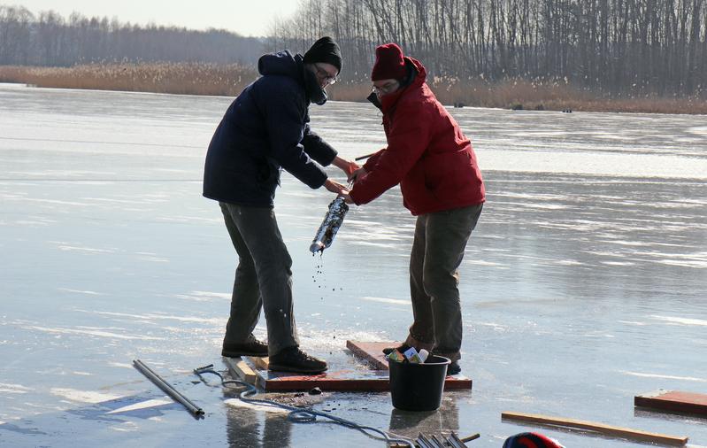 Dr. Olaf Juschus (links im Bild) entnimmt zusammen mit Dr. Martin Theuerkauf von der Universität Greifswald Proben aus den Tiefen des Wesensee. Dafür haben sie Löcher ins Eis gebohrt.