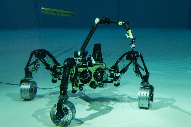 Das autonome Unterwasserfahrzeug (AUV) "Leng" und der Unterwasser-Rover "Sherpa-UW" erkunden gemeinsam das große Salzwasserbecken in der Maritimen Explorationshalle des DFKI in Bremen. 