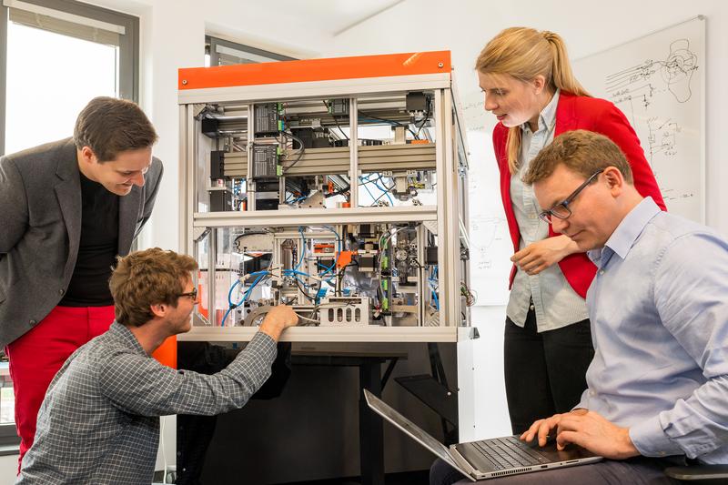 Dominik Sievert (links) und Maria Driesel (2. von rechts), Gründer von inveox mit dem Prototyp ihres Automaten zur Erfassung medizinischer Proben. 