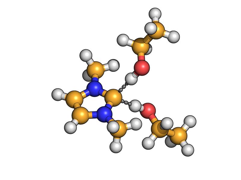 Das Kohlenstoff-Atom des Carbens (gelb) bildet gleichzeitig Wasserstoffbrücken (gestrichelt dargestellt) zu zwei Molekülen aus. 