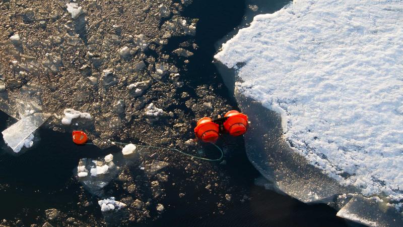 A mooring appears at the ocean's surface.