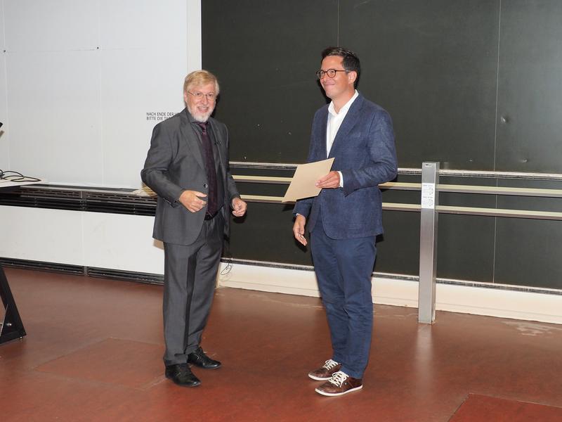 ÖPG's President Reinhold Koch congratulates Johannes Fink during the award ceremony