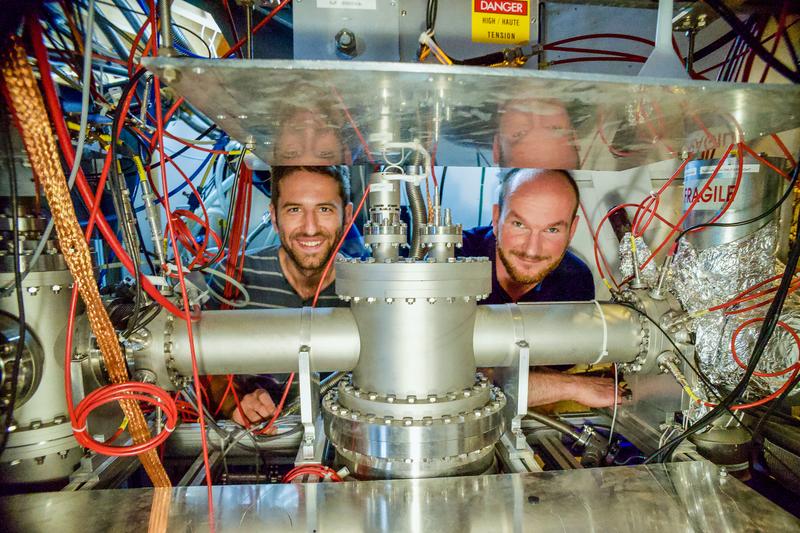 Dinko Atanasov (MPIK Heidelberg, left) and Frank Wienholtz (Uni Greifswald and CERN) behind the MR-ToF MS component of the ISOLTRAP setup in the ISOLDE experimental hall at CERN
