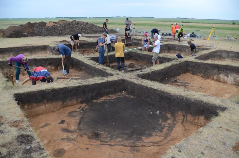 Trans-Ural region. Konopljanka-2 Bronze Age terraced house settlement with a filled-in well shaft in the foreground. 2018 excavation. 