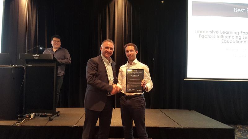 Prof. Edmundo Tovar, Universidad Politécnica Madrid and Vice-President of the IEEE Education Society, congratulates Andreas Dengel. In the back: Mark Lee, one of the conference organisers.