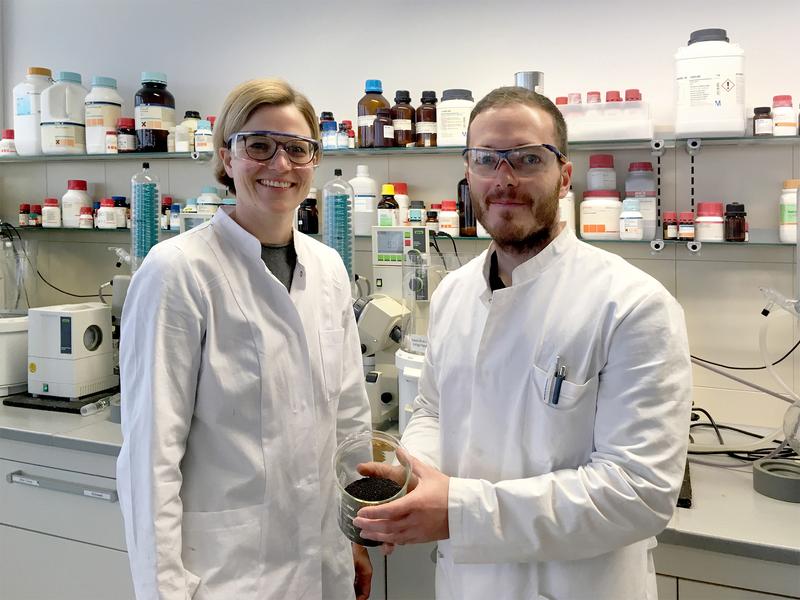 Corinna Dawid and Christoph Hald presenting a glass beaker with rapeseed in their laboratory at the chair for Food Chemistry and Molecular Sensory Science at the Technical University of Munich.