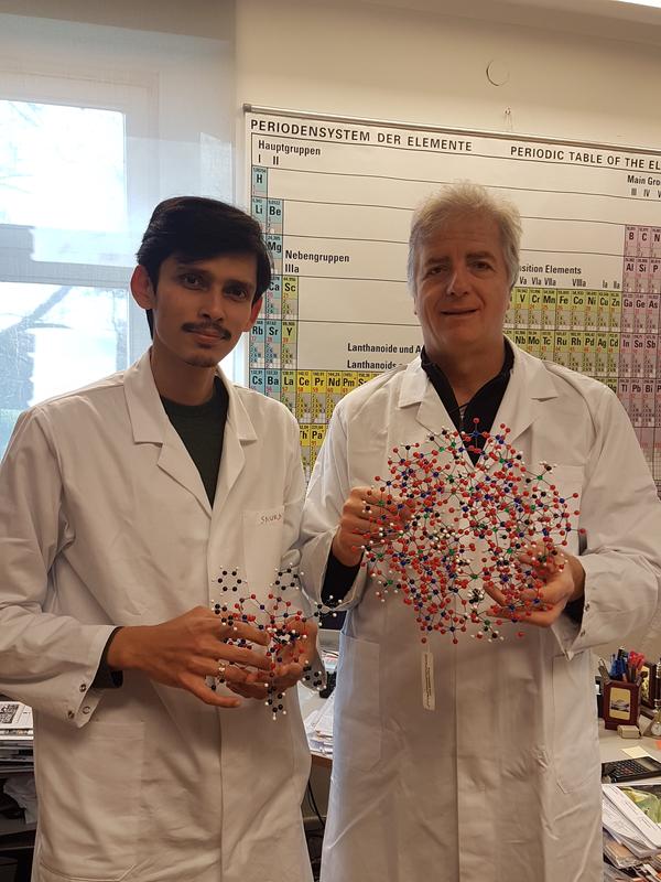 Ulrich Kortz, Professor of Chemistry at Jacobs University in Bremen, and his colleague Dr. Saurav Bhattacharya with a POM model.