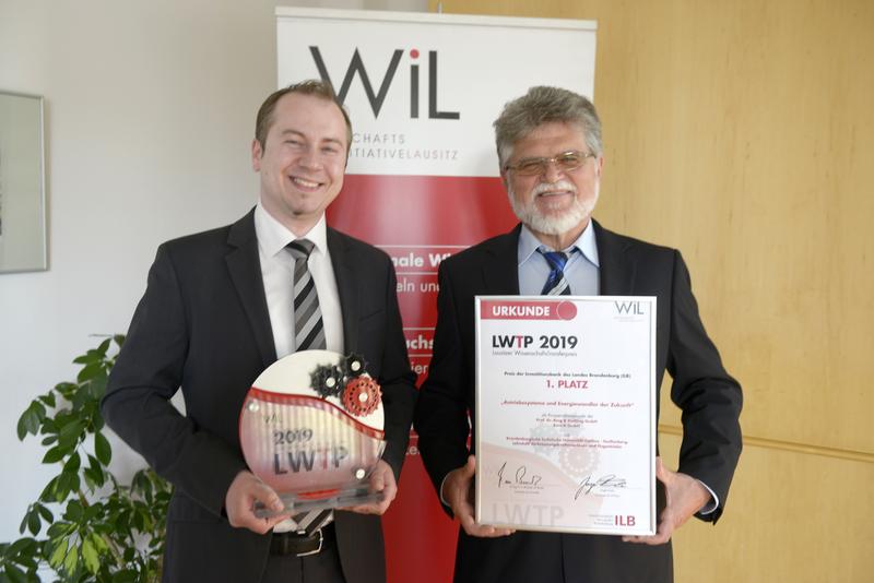 Johannes Mundstock (l.) von der Euro-K GmbH und Prof. Dr.-Ing. Heinz Peter Berg, Leiter des BTU-Lehrstuhls Verbrennungskraftmaschinen und Flugantriebe freuen sich über den ersten Platz.