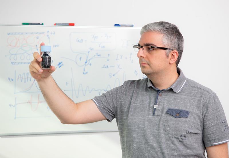 Ali Gooneie looks at a sample from his most recent research project: electrically conductive polymers. The first calculations for his next project are sketched out on the blackboard.