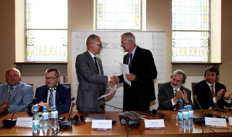 Prof. Wojciech Strzyżewski and Prof. Tillack (centre f.l.t.r.) congratulate each other to the inauguration of the Joint Lab in the senate hall of the University of Zielona Góra. 