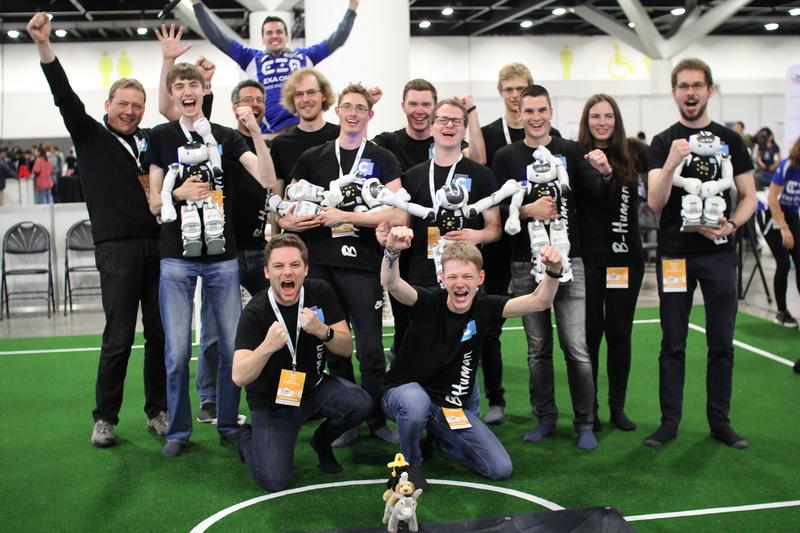 he B-Human team celebrating a few minutes after the win of the Standard Platform League Competition at RoboCup 2019 in Sydney.