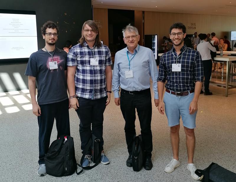 Die Doktoranden Ioannis Matthaiakakis, Tobias Müller und Raúl Stühler aus Würzburg (von links) begegnen in Lindau Physik-Nobelpreisträger Klaus von Klitzing.