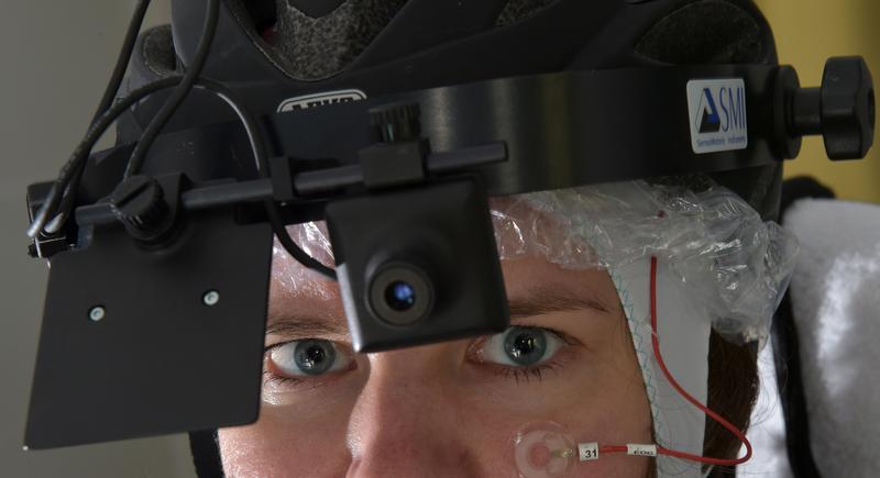 The psychologist Dr Barbara Schmidt with bicycle helmet, on which an eyetracker is mounted.