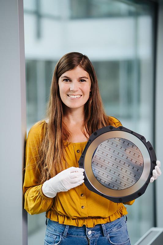 Quantum physicist Silke Auchter with a wafer containing about 1,000 chips for quantum research.