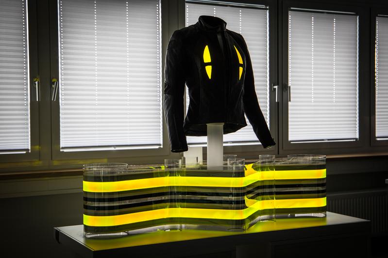 Motorcycle jacket with integrated flexible OLED
