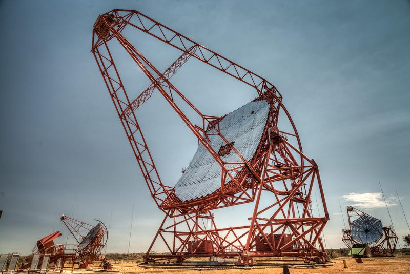 The huge central H.E.S.S. telescope with 614 m² mirror area and two of the four smaller telescopes, each with 107 m² mirror area.