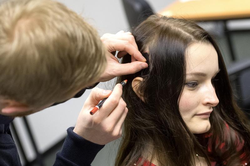 Die Wissenschaftler bringen Elektroden am Kopf einer Testperson an. Bild: Universität Oldenburg