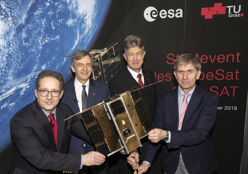Celebrating the successful launch of ESA's CubeSat OPS-SAT: representatives from TU Graz (centre), ESA in Darmstadt (right) and Austria's Aeronautics and Space Agency (left)