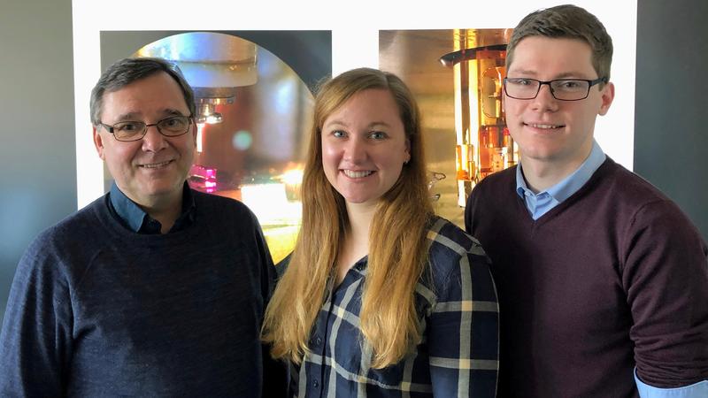 Dr Martin Wenderoth, Anna Sinterhauf and Georg A Traeger with pictures of the scanning tunnelling microscopes in the background.