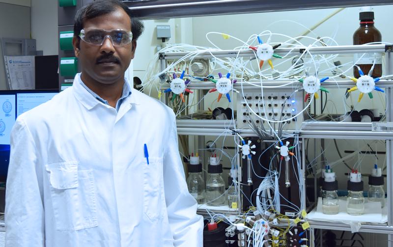 Dr. Abragam Joseph in front of the home-built carbohydrate synthesis instrument. 