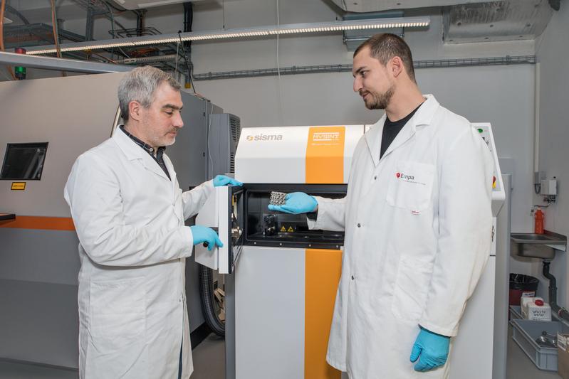 Christian Leinenbach und Ariyan Arabi-Hashemi nutzen einen 3D-Laserdrucker zum Feintuning von Edelstahl-Legierungen.