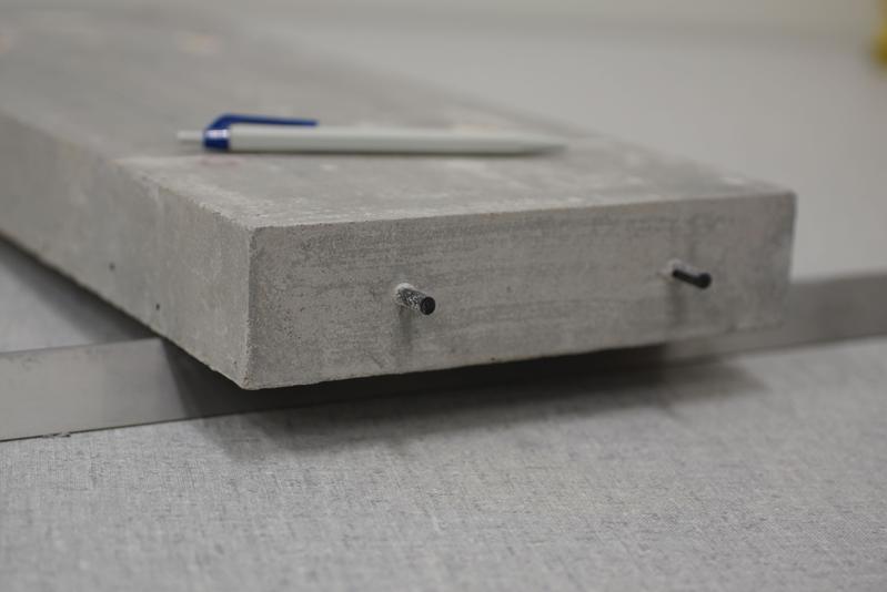 A beam made of self-pre-stressed concrete with carbon ﬁber reinforced plastic (CFRP) as reinforcement. 