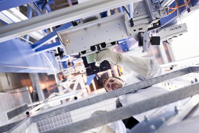 Blick in den Faserziehturm des Leibniz-IPHT. Das Technologiezentrum deckt den gesamten Fasertechnologieprozess ab und erlaubt die Herstellung optischer Fasern, die als Lichtquellen und faseroptische Sensoren sowie in Endoskopen zum Einsatz kommen.