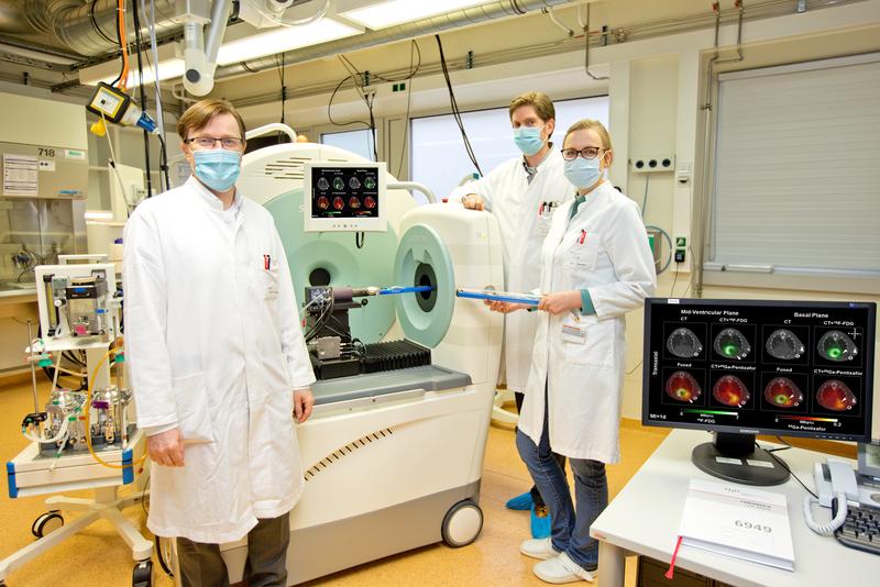 Professor Dr. Frank Bengel, James Thackeray PhD und Annika Heß, PhD vor einem Positronen-Emissions-Tomografen (PET).