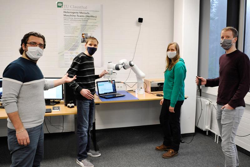 Ein forschendes Mensch-Maschine-Team (von links): Basel Alhaji, Niels Rohweder, der kollaborative Roboter CoRA, Janine Beecken und Felix Merz.