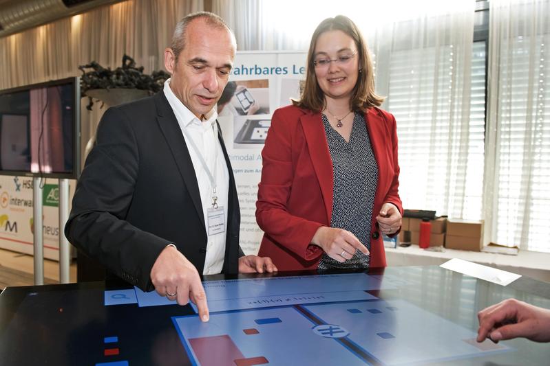 TZI managing director Professor Rainer Malaka and staff member Anke Reinschlüssel next to a prototype of a digital table that can help in math lessons in schools.