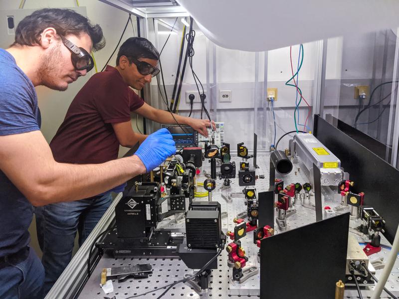 Carlos Saavedra (left) and Deepak Pandey (right) prepare the optical microfilter for test measurements. 