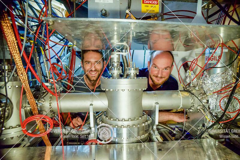 Dinko Atanasov and Frank Wienholtz (on the right) behind the MR-ToF MS component of the ISOLTRAP setup in the ISOLDE experimental hall at CERN