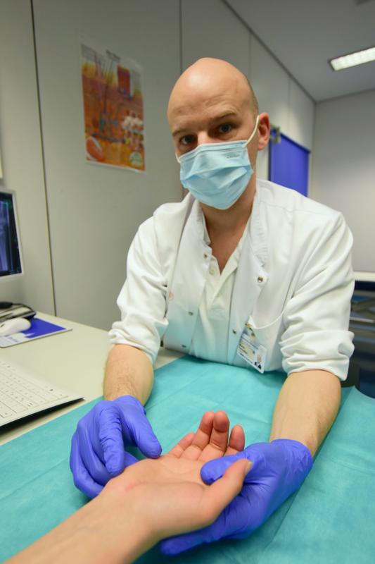 Dr. Martin Schreiber, Leitender Oberarzt  der Abteilung für Plastische- und Handchirurgie des UniversitätsCentrums für Orthopädie, Unfall- und Plastische Chirurgie (OUPC) schaut auf die noch leicht gerötete Stelle des Eingriffs.
