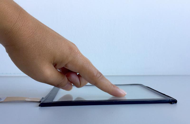 A finger touching a screen