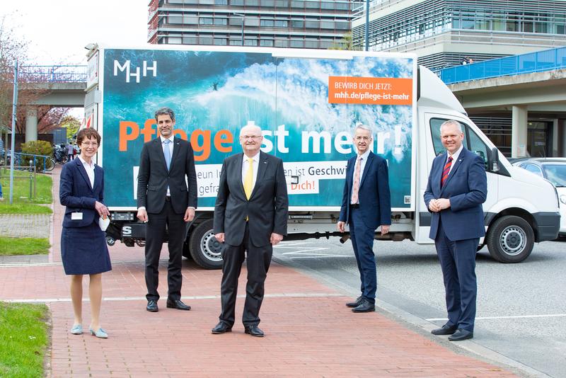 Martina Saurin, Andreas Fischer, Professor Dr. Michael Manns, Professor Dr. Frank Lammert und Minister Björn Thümler vor einem Plakat der MHH-Pflegekampagne. 