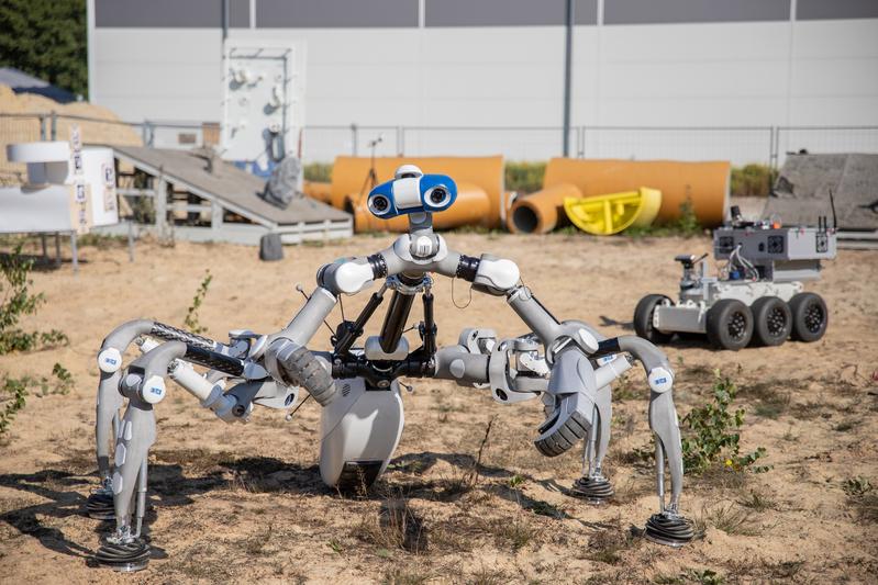 The walking robot Mantis and the rover VELES during tests on the DFKI's outdoor premises in Bremen 